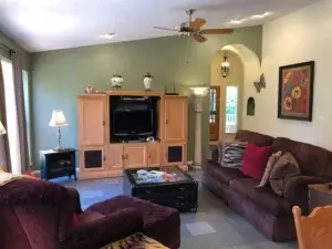 living room with couches and media console