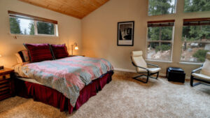 bedroom with seating and large windows