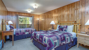 bedroom with two beds and purple bedding