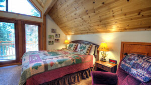 bedroom with tall wood ceilings and balcony access