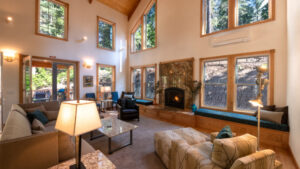 living room with stone fireplace and vaulted ceiling