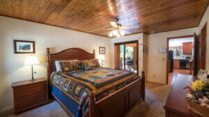 bedroom with wood paneled ceiling and large bed
