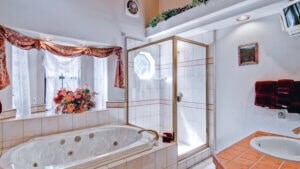 bathroom with jet tub and walk in shower