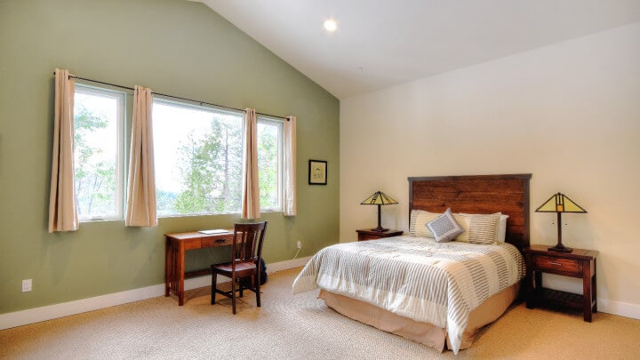 bedroom with queen bed and high ceilings