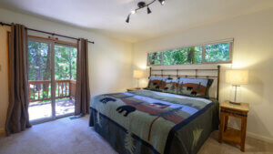 bedroom with window and doors to deck