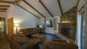 living room with fireplace and beams