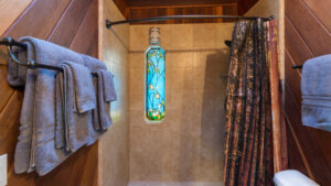 bathroom with stained glass window in shower