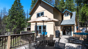 deck with outdoor seating and view of exterior of house