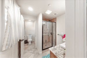 bathroom with walk in shower and toilet room