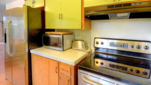 kitchen with green upper cabinets