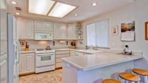 light kitchen with white cabinets and appliances
