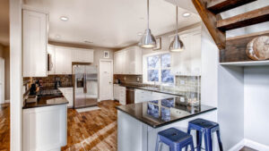 kitchen with white cabinets and black countertops