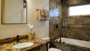 bathroom with stone accents and bathtub