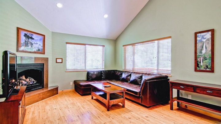 living room with couch, television, and fireplace