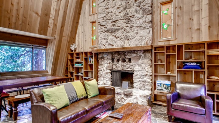 living room with stone fireplace