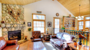 living room with stone fireplace and seating