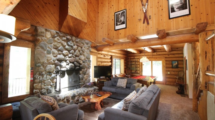 living room with stone fireplace and seating