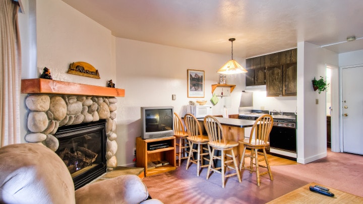 living room overview with fireplace and television