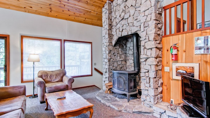 living area with stone fireplace