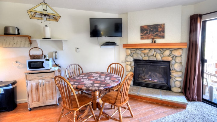 dining area with television and fireplace