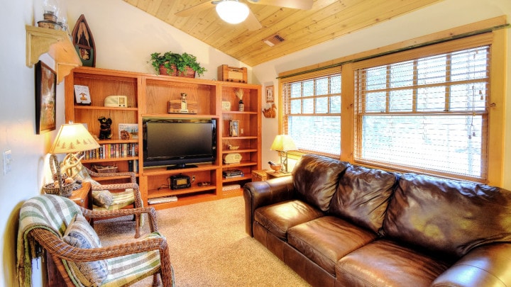 lofted living room area with television and couches