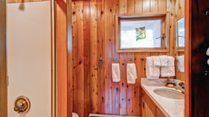 bathroom with wood paneling