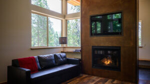 living room with tall ceilings, television, and fire place