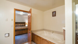 en suite bathroom with spa tub