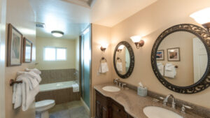 bathroom with shower tub and double vanity