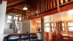 living room with couches, view to loft