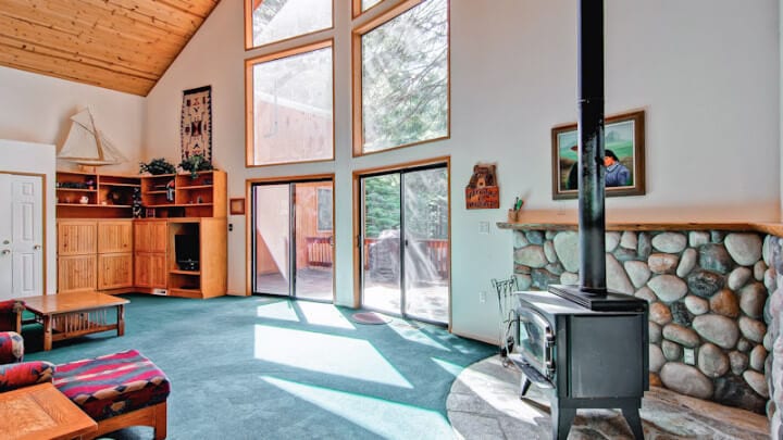 living room with large windows and wood stove