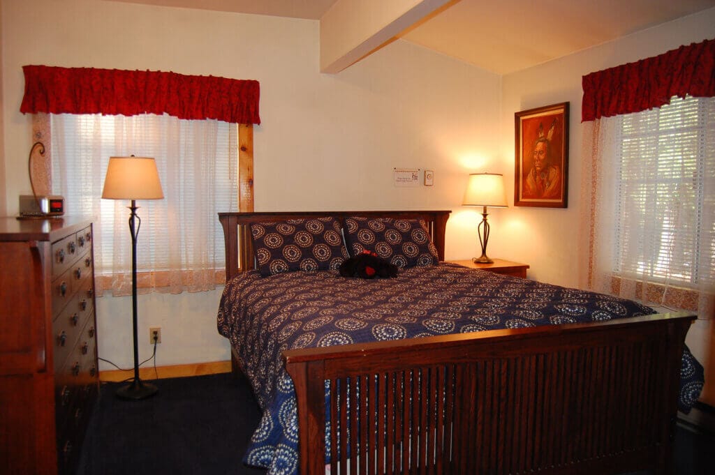 bedroom with floor lamps and windows