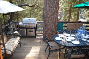deck with outdoor dining and grill