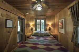 bedroom with sconces and windows