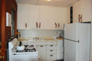 white kitchen with wood handles