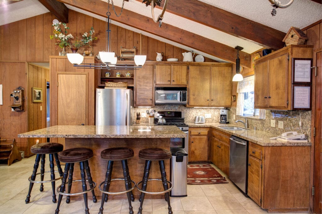kitchen with wood cabinets and beams, island seating