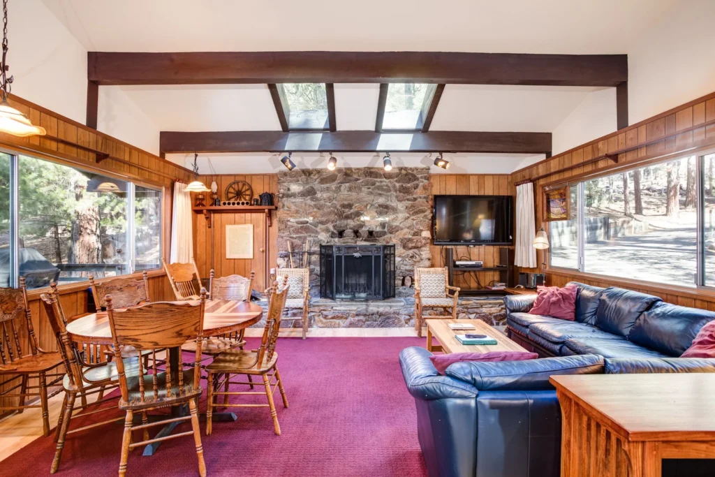 living room with stone fireplace and seating