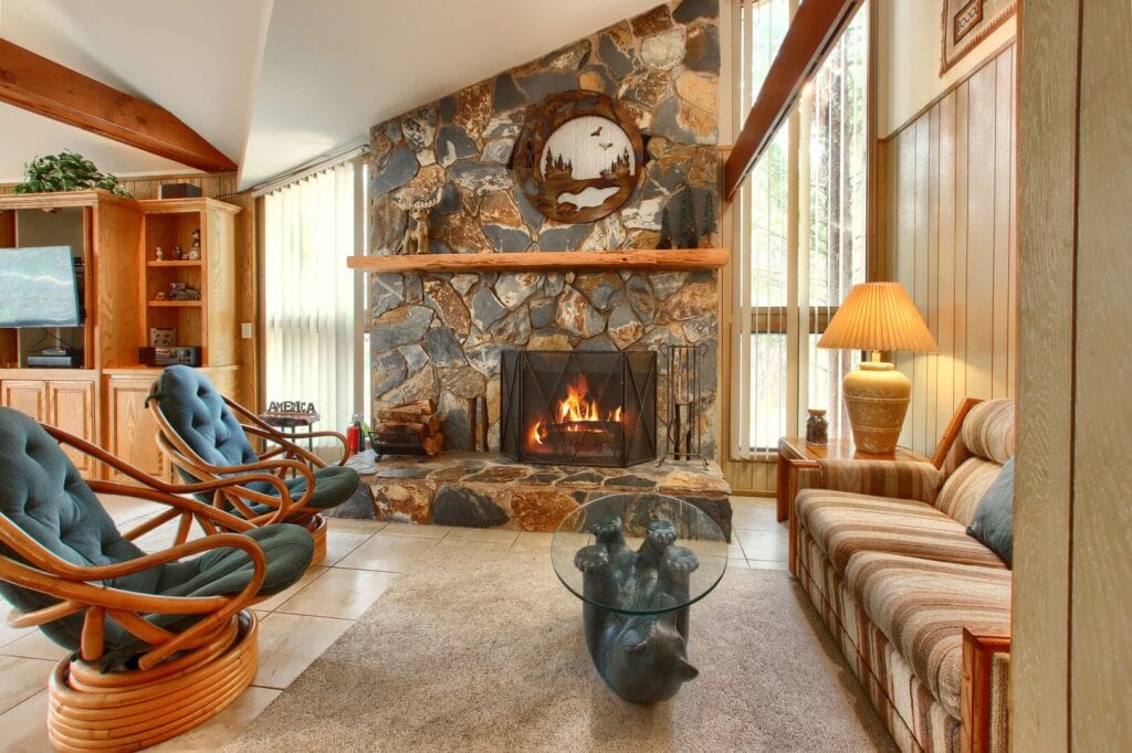 living room with stone fireplace and seating