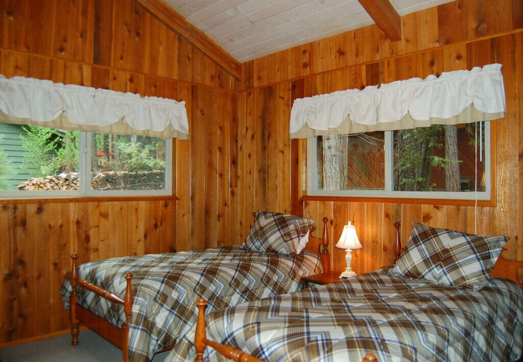 bedroom with wood paneling and tao twin beds