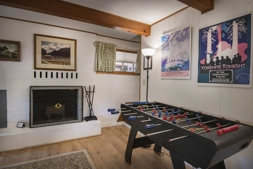 game room with foosball table and fireplace