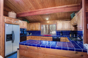wood kitchen with blue tiles
