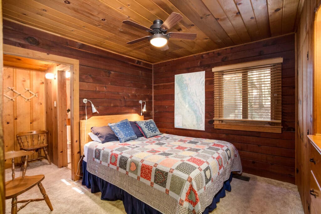 bedroom with wooden walls and ceiling