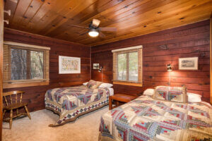 double beds with wood walls and ceiling