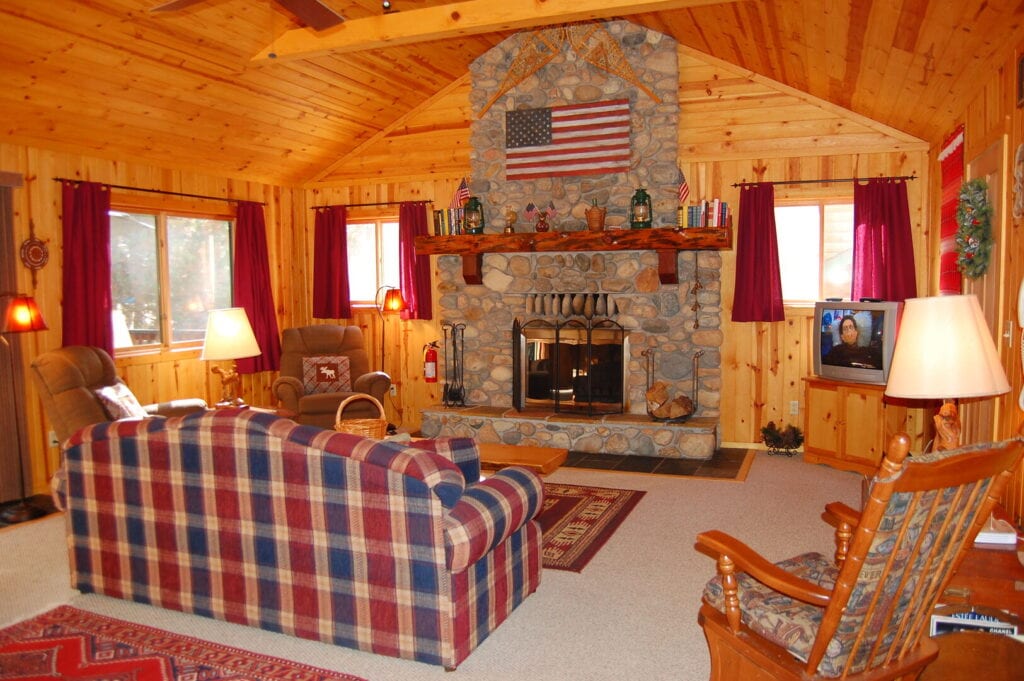 living room with couch and stone fireplace