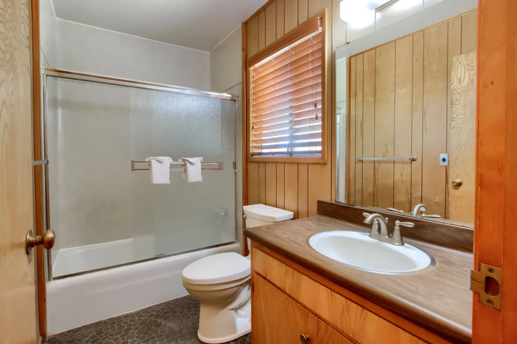 bathroom with shower bath combo, toilet, and vanity