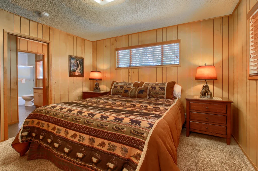 bedroom with patterned bedspread and window