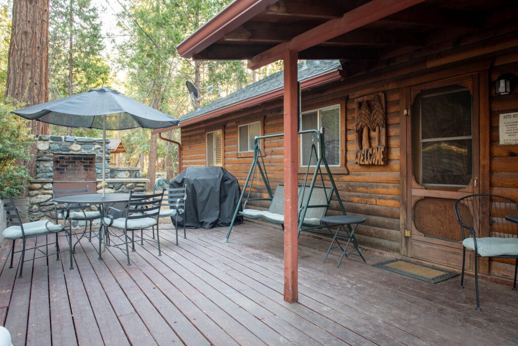deck with outdoor seating, grill, and outdoor fireplace