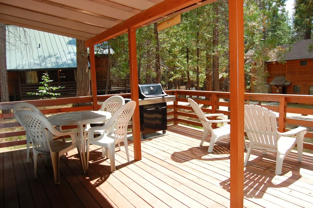 covered deck with outdoor seating and grill