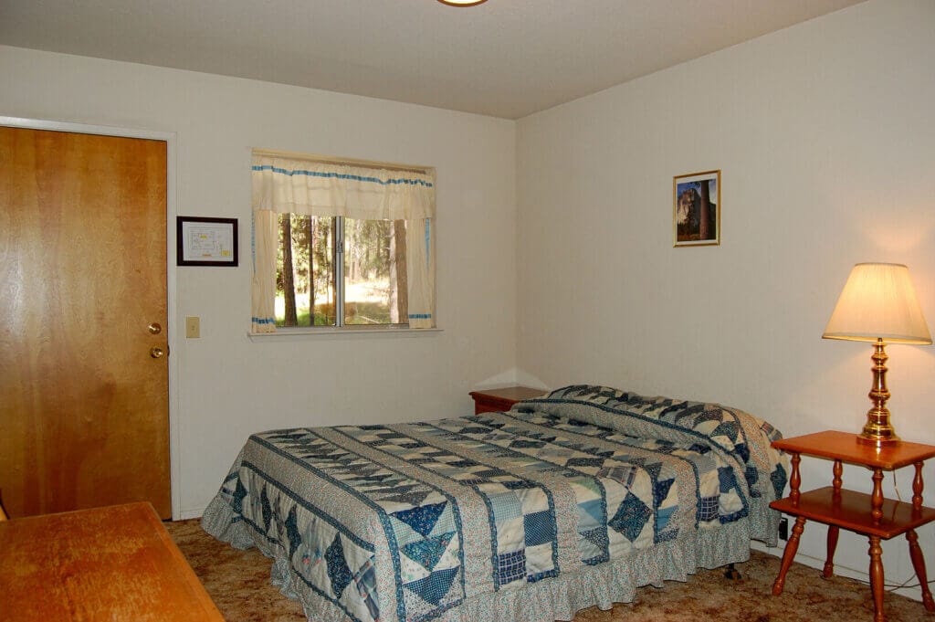 bedroom with bed and small window