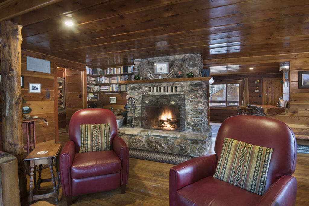 living room with stone fireplace and seating